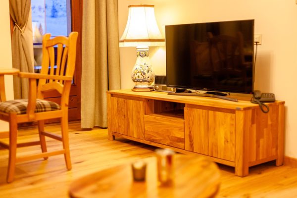 landhaus-apartments-appartement-15-wohnzimmer-tv-sideboard-massivholz Wohnzimmer im Apartment #15 mit TV, Sideboard und Massivholzmöbeln